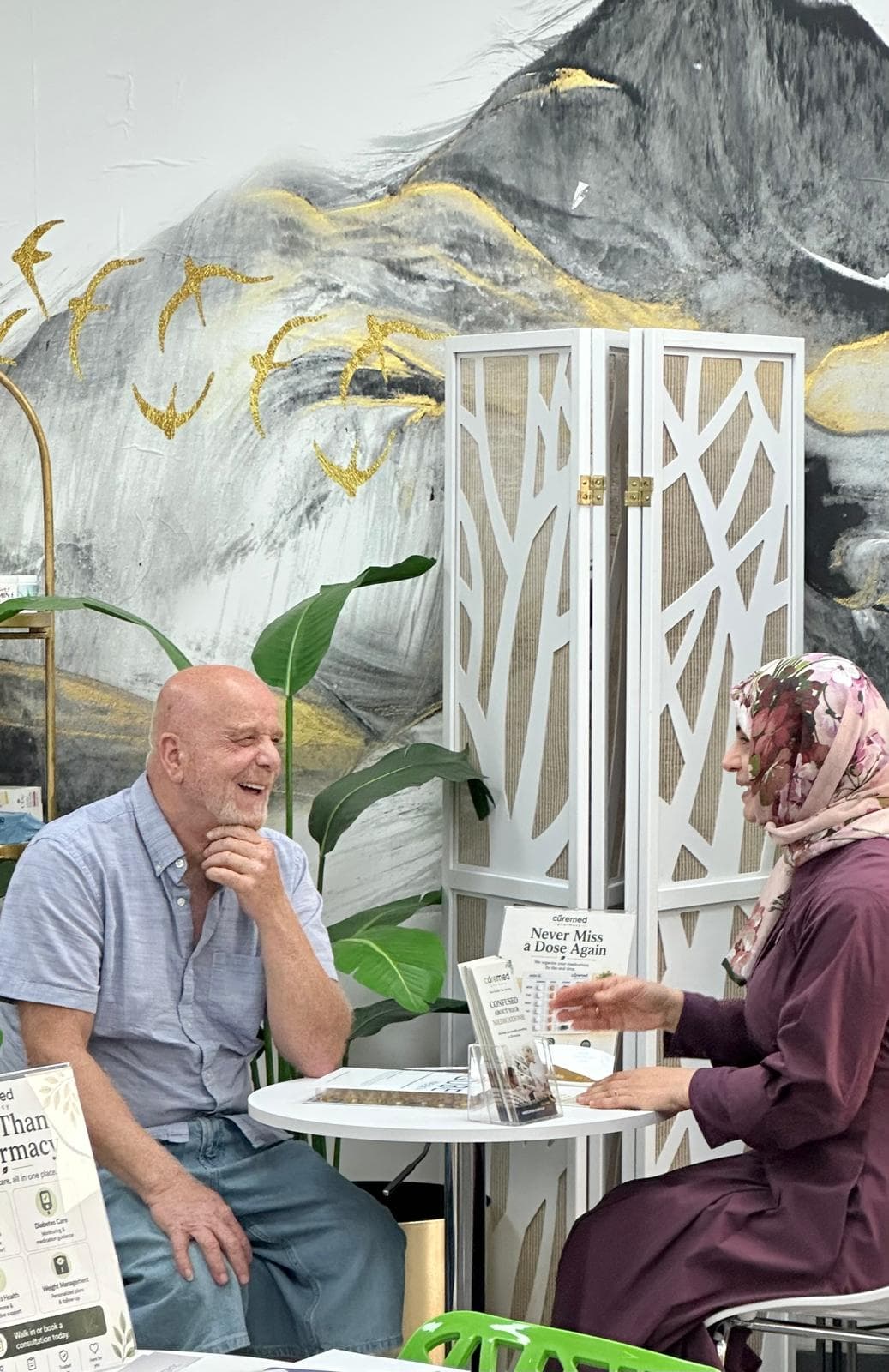 Pharmacist consulting a patient at CureMed Pharmacy